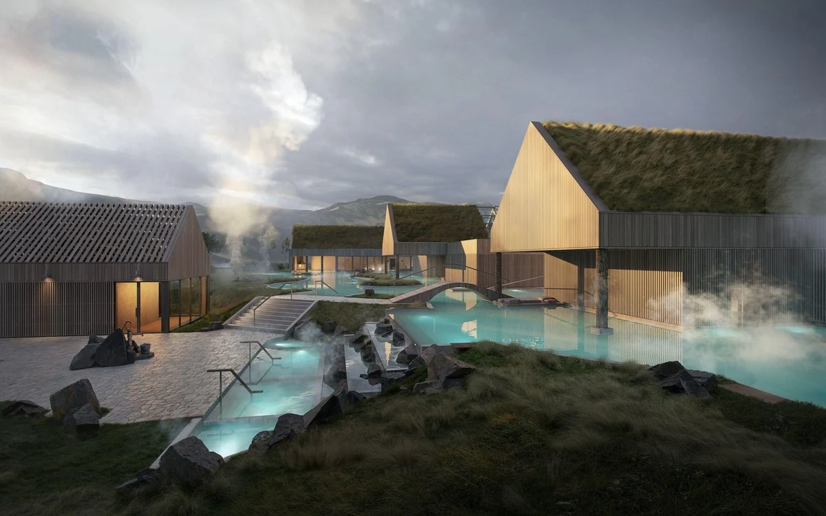 Warm pools built into a grassy slope with wooden decking around them
